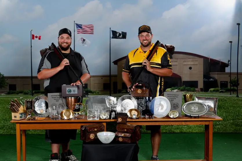 Matt and Foster Bartholow with Citori over under shotguns and trophies from 2019 Grand American