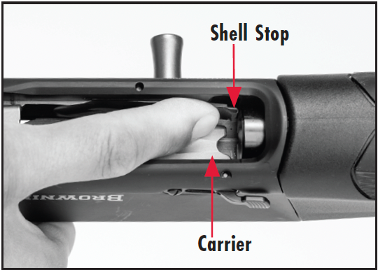 Push inward on the shell stop to unload the magazine.