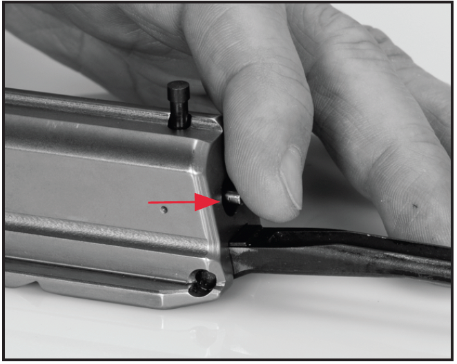 Push in the firing pin until it is almost flush with the rear of the slide assembly, then install the firing pin retaining pin.