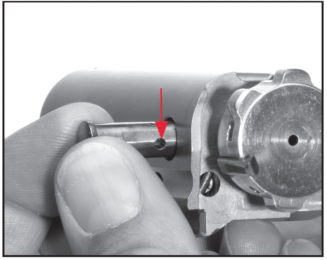 Install the unlocking pin as shown. The hole must align with the firing pin.