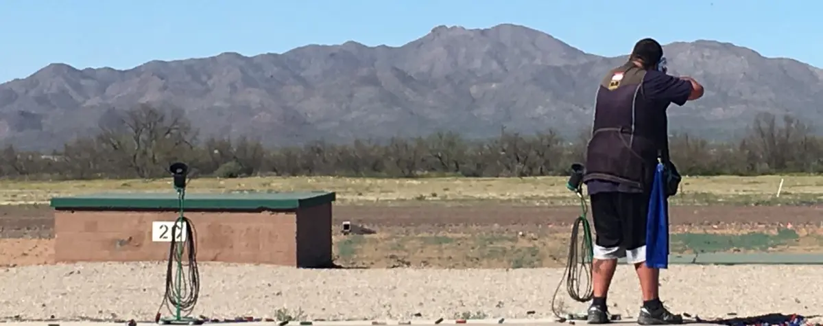 Matt Bartholow standing on trap line shooting shotgun